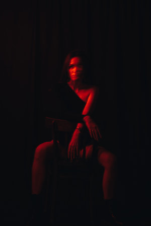 blurry portrait of a girl with mental disorders sitting on a chairの写真素材