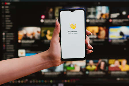 VICHUGA, RUSSIA - FEBRUARY 20, 2021: smartphone with logo of new trending app Clubhouse drop-in...