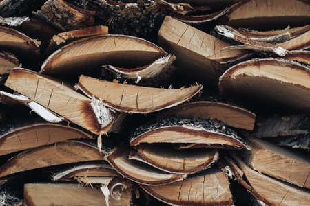 woodpile of birch wood. Texture of logs to light a fireの写真素材