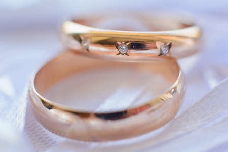 two gold wedding rings with diamonds for engagementの写真素材