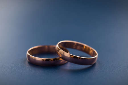 two traditional wedding gold engagement rings close-upの写真素材