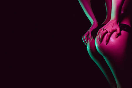 sexy ass of girl in panties with her hands digging into skin. Silhouette of beautiful slender female...