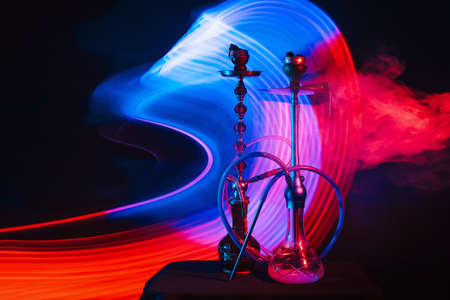 smoky Turkish hookahs with coals on bowls and water in flasksの写真素材