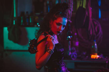 girl in a futuristic cyberpunk costume with neon lighting. The concept of the future post-apocalypseの写真素材