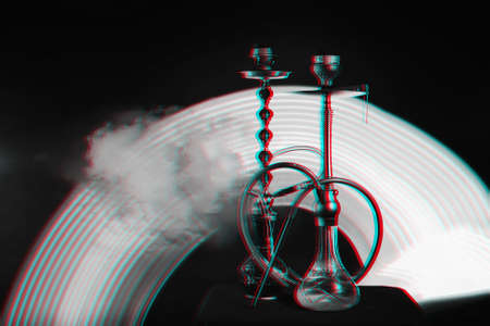 two hookahs with coals in the smoke