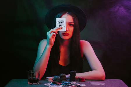 poker player at a casino table with cards and chipsの写真素材
