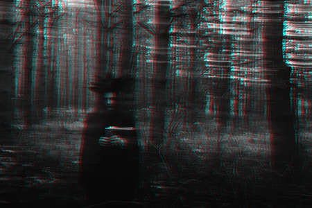 dark terrible witch with candles in her hands performs an occult mystical ritual in the forest