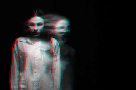 blurry scary portrait of a witch ghost girl in a white shirt. Black and white with 3D glitch virtual reality effectの写真素材