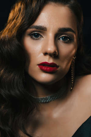 Portrait of a young woman in Hollywood retro noir style. A beautiful brunette girl with a hairstyle and makeupの写真素材