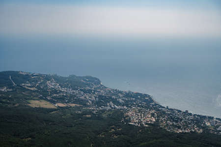 View of city of Yalta in Crimea on Black Sea coast from the height of the top of Ai-Petri mountainの写真素材