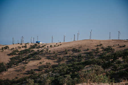 wind turbines at a wind farm in the mountains to produce eco-friendly energy