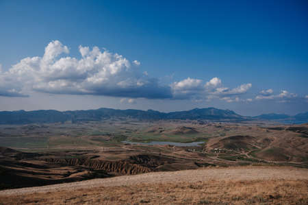 Landscape with a lake in mountains under a blue skyの写真素材