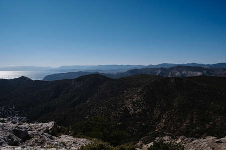 Landscape panorama with mountains in summer by sea under a blue skyの写真素材