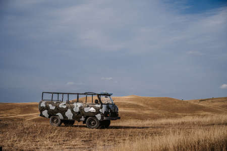 Republic of Crimea, Russia - August 27, 2021: SUV jeep for tourist excursions are in field in summer