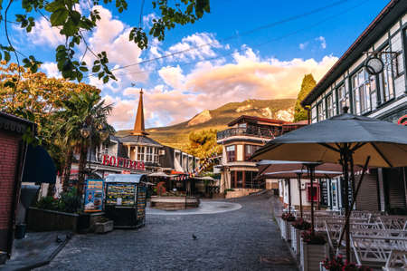 GURZUF, RUSSIA - SEPTEMBER 1, 2021: beautiful ancient cobblestone street with historical buildings...