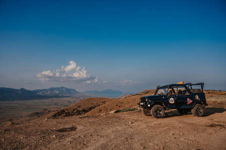 Republic of Crimea, Russia - August 24, 2021: SUV jeep for excursions is in mountains in summer on sunny dayのeditorial素材