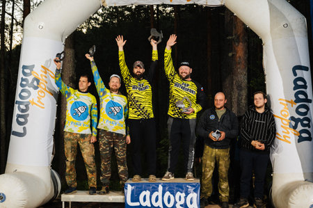 REPUBLIC OF KARELIA, RUSSIA - CIRCA JUNE, 2022: Off-road tournament Ladoga Trophy 2022 in Karelia. Awarding ceremony on podium with cups of winners of raceのeditorial素材