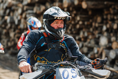 REPUBLIC OF KARELIA, RUSSIA - CIRCA JUNE, 2022: Off-road tournament Ladoga Trophy 2022 in Karelia. A motorcycle racer in a helmet sitting on a sports motorcycleのeditorial素材