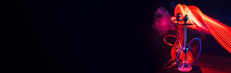 two hookahs with shisha coals and smoke with red and blue neon lightingの写真素材