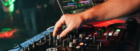 hands of a DJ in a booth playing on the mixerの写真素材