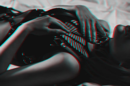 slender woman with a sexy body in erotic underwear lies beautifully on a bed in a bedroomの写真素材