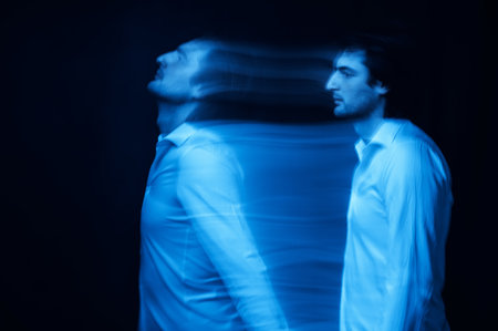 blurred silhouette of ghost mans soul on a dark background