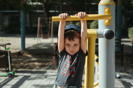 kindergarten child boy playing with a simulator on playgroundの写真素材