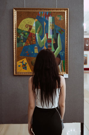 SHYMKENT, KAZAKHSTAN - MARCH 26, 2023: girl looks at a painting at an exhibition at Museum of Fine Arts in Shymkentのeditorial素材