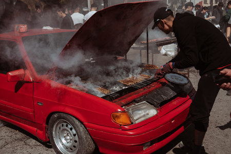 SHYMKENT, KAZAKHSTAN - MARCH 22, 2023: kazakh man cooking barbecue for celebration of Nauryzのeditorial素材
