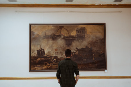 SHYMKENT, KAZAKHSTAN - MARCH 26, 2023: man looks at a painting at an exhibition at Museum of Fine Arts in Shymkentのeditorial素材
