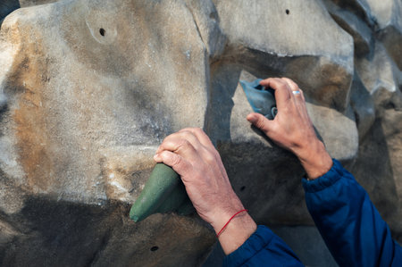 hands of male climber training on climbing wallの写真素材