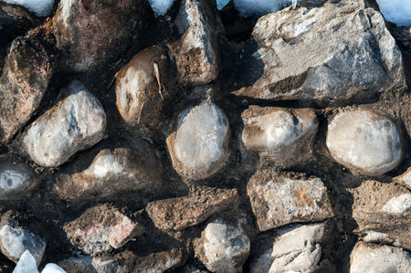 texture of cobblestone stones in a concrete wallの写真素材