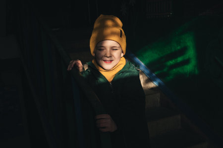 portrait of happy Caucasian child boy on the stairs in the entrance
