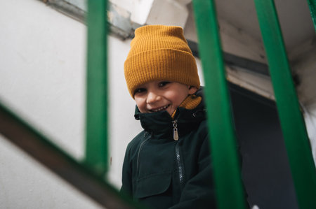 happy Caucasian child kid boy on stairs in the entrance