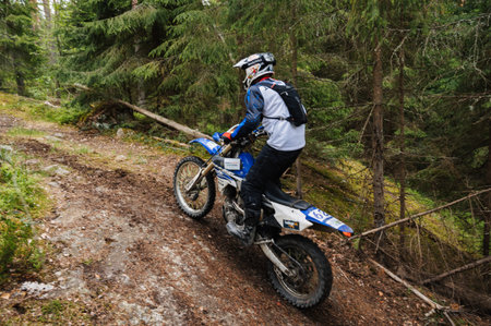 REPUBLIC OF KARELIA, RUSSIA - CIRCA JUNE, 2022: Off-road tournament Ladoga Trophy 2022 in Karelia. Motorcyclist on an enduro sports motorcycle rides in a motocross raceのeditorial素材