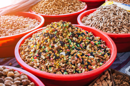 traditional Uzbek sweet mix of various varieties of nuts, dried fruits, oriental sweets on the...