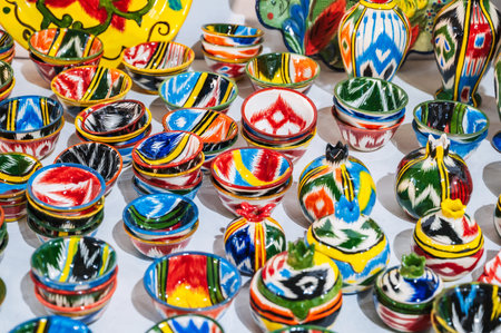 Uzbek ceramic cups and handmade tableware with hand-painted traditional Asian colorful patterns at oriental bazaarの写真素材