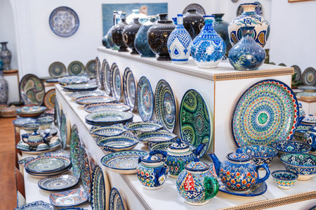 Uzbek handmade ceramic plates and tableware with hand-painted traditional Asian colorful patterns in souvenir storeの写真素材