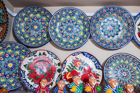 Uzbek handmade ceramic plates and figurines with hand-painted Oriental Asian patterns in souvenir storeの写真素材