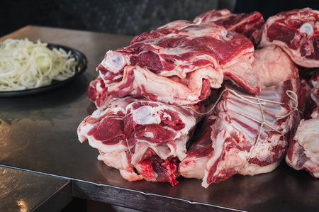 Fresh raw lamb meat on counter for cooking traditional Asian Uzbek pilaf in restaurant Besh Qozon in Tashkent in Uzbekistanの写真素材