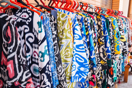 Indian dresses made of silk fabric with a bright colorful pattern at oriental bazaar in India