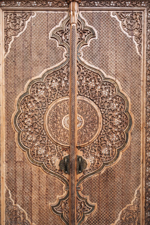 Wooden door with carved oriental pattern Uzbek ornament in Museum of Victims of Political Repression in Tashkent in Uzbekistan close-upの写真素材