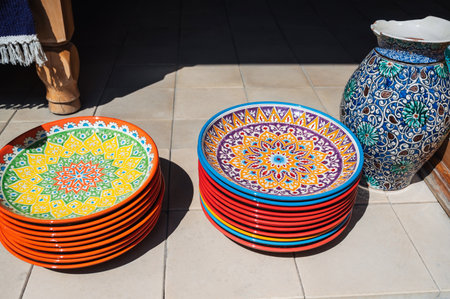 traditional colorful Uzbek plates and ceramic vase hand-painted at street oriental market in Uzbekistanの写真素材