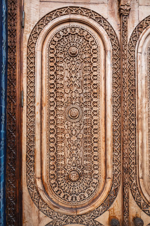 oriental arab pattern Uzbek traditional ornament on wooden carved door in Tashkent in Uzbekistan closeupの写真素材