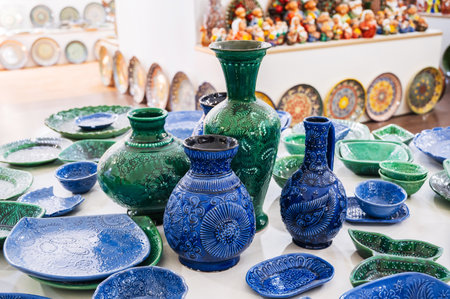 Uzbek handmade ceramic plates, vases and jug with hand-painted traditional Asian patterns in pottery workshopの写真素材