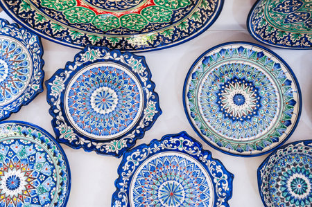 Uzbek handmade ceramic plate with hand-painted Islamic pattern in pottery workshop