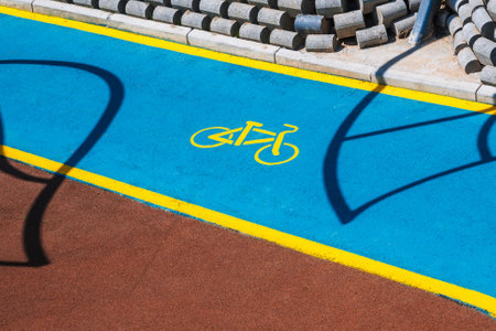 bicycle symbol on a modern new bike path painted with blue paint in park in Tashkent in Uzbekistanの写真素材