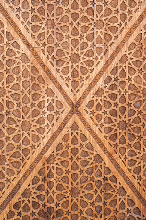 asian Uzbek Islamic patterns ornament with stars on modern wooden carved door in Uzbekistan close-up
