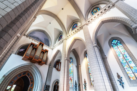 interior inside of Christian Catholic church with organ pipes on the wall. Sacred Heart of Jesus Cathedral in Tashkent in Uzbekistanの写真素材