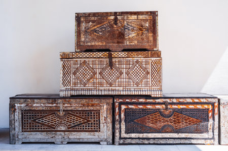 four vintage traditional antique Uzbek handmade wooden chests with a pattern on metal lining in...